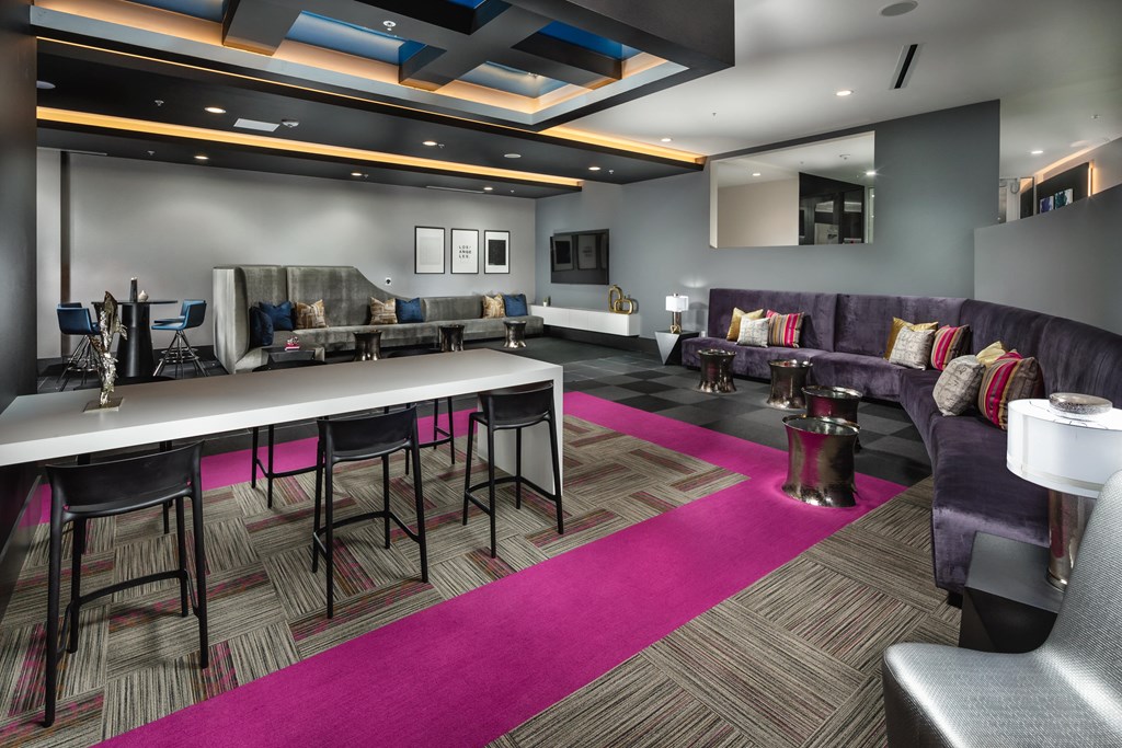 a lounge area with tables and chairs and couches