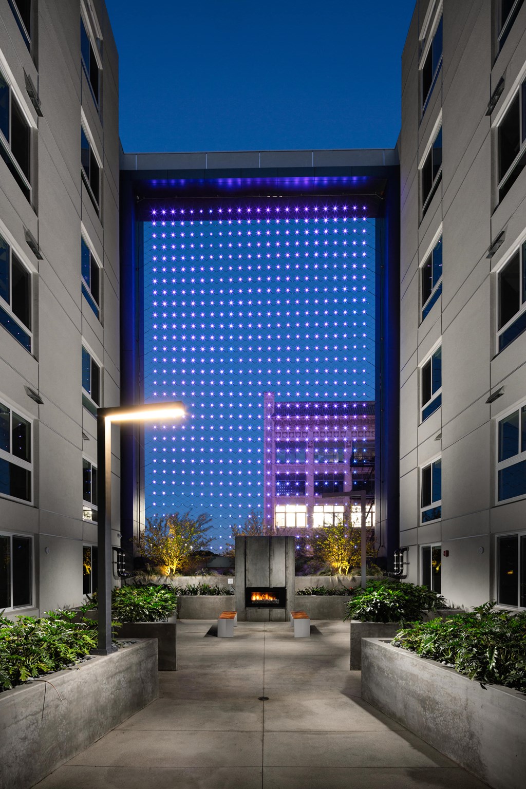 a lobby with a large building in the background at night