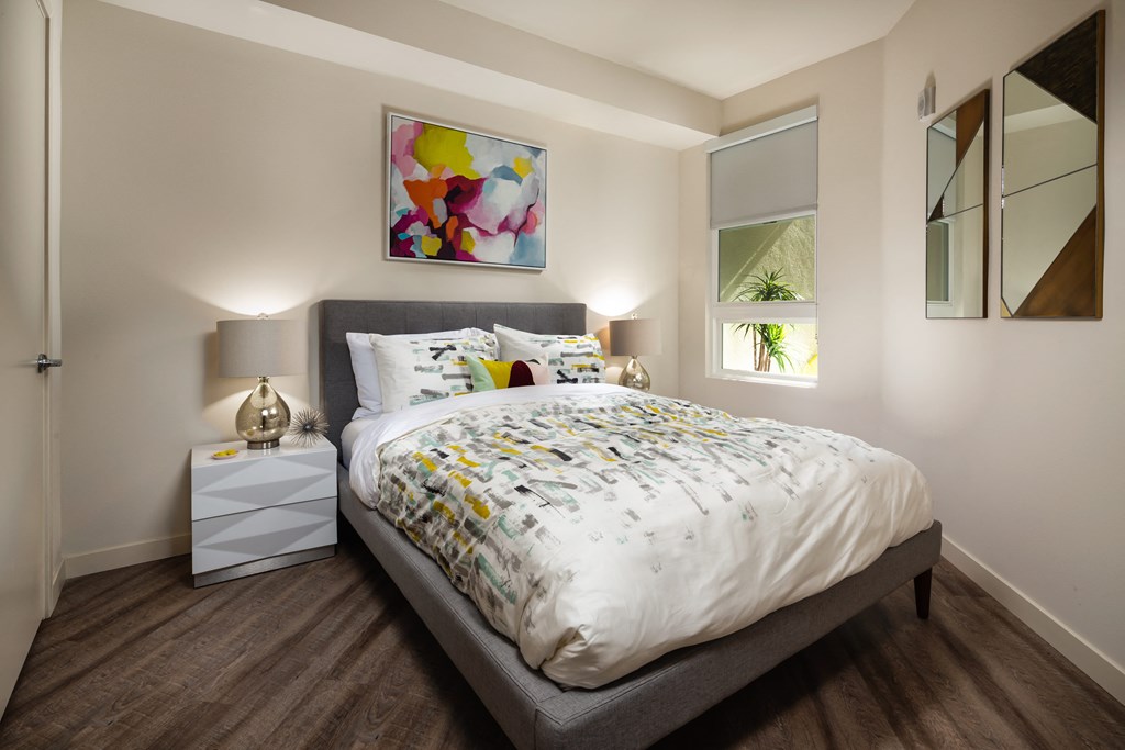 a bedroom with a bed with a comforter