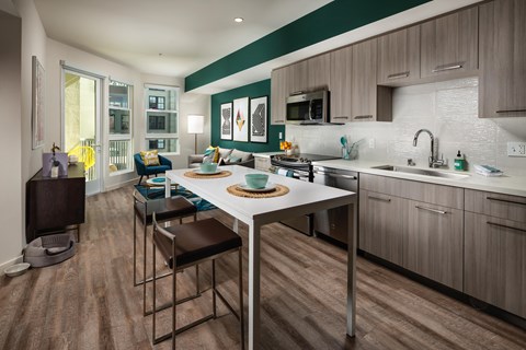 a kitchen and dining room with a white table and chairs