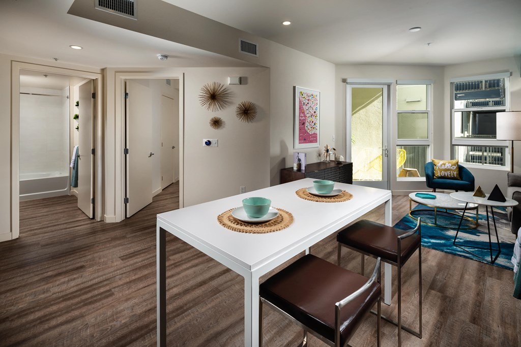 a dining room with a white table and chairs