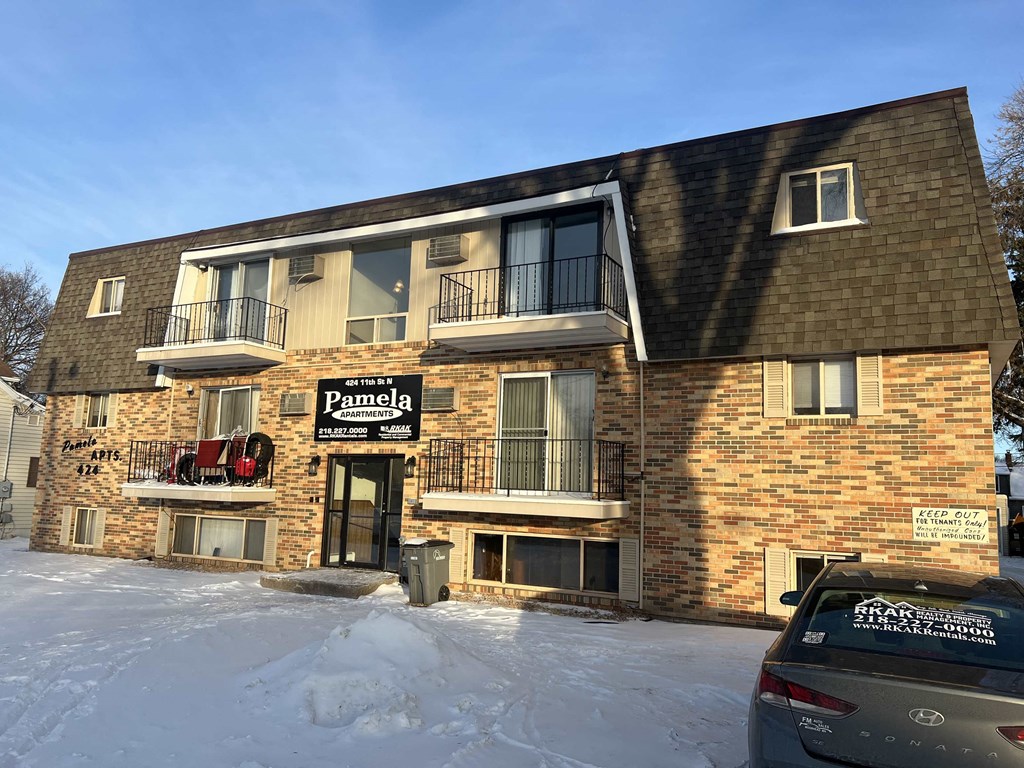 a building with a parking meter in the snow