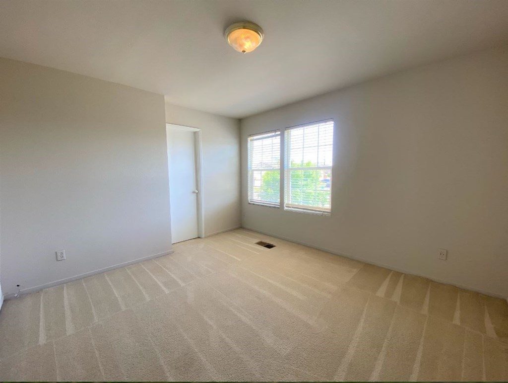 the living room of an empty house with a window