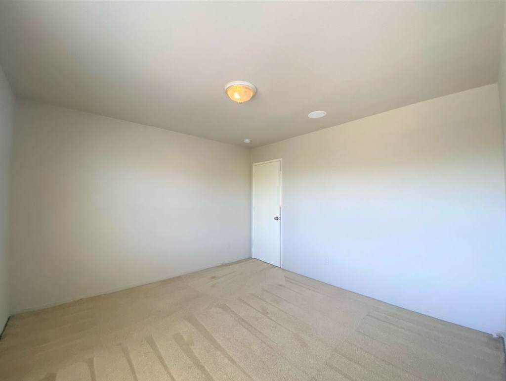a empty room with white walls and a door