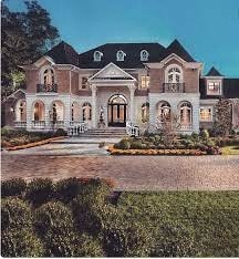 A large, grand house with a symmetrical facade and a central entrance.