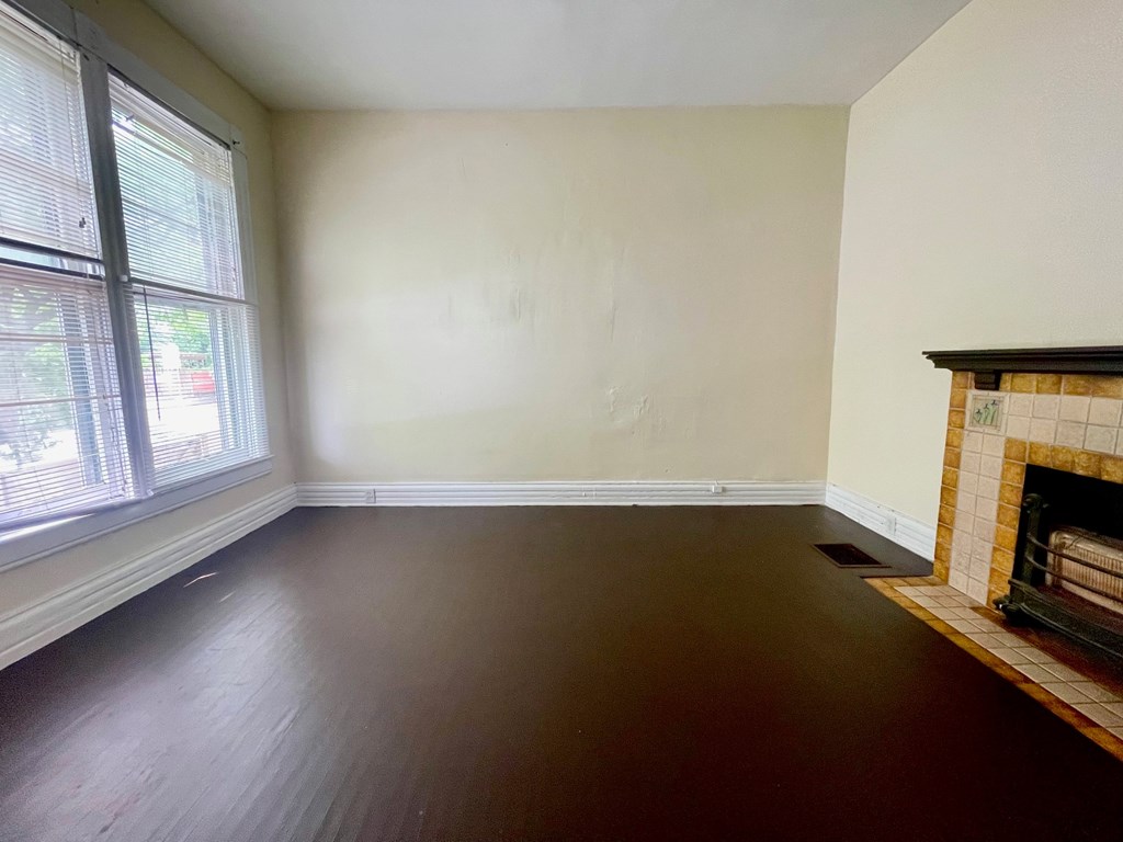 A room with a fireplace and a window.