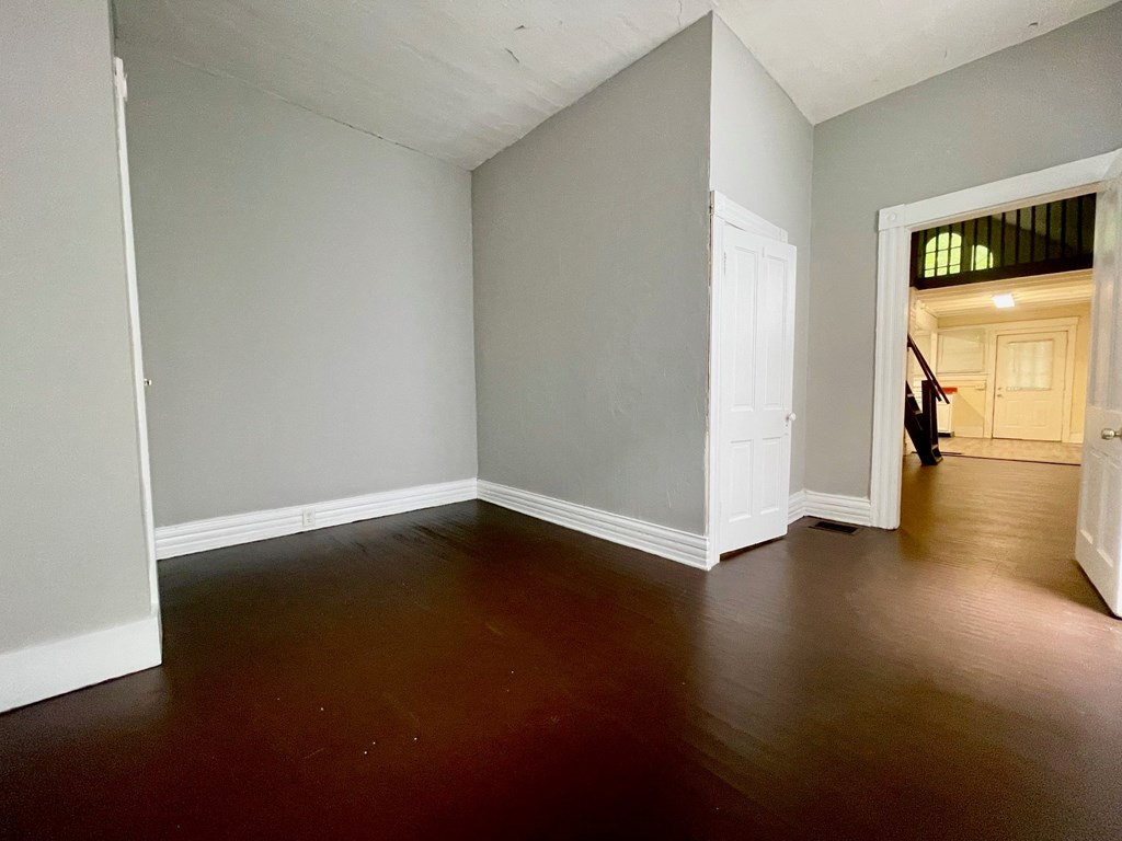 A room with a wooden floor and white walls.
