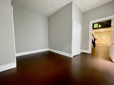 A room with a wooden floor and white walls.
