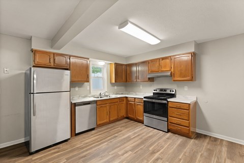 A kitchen with wooden cabinets and a white refrigerator.