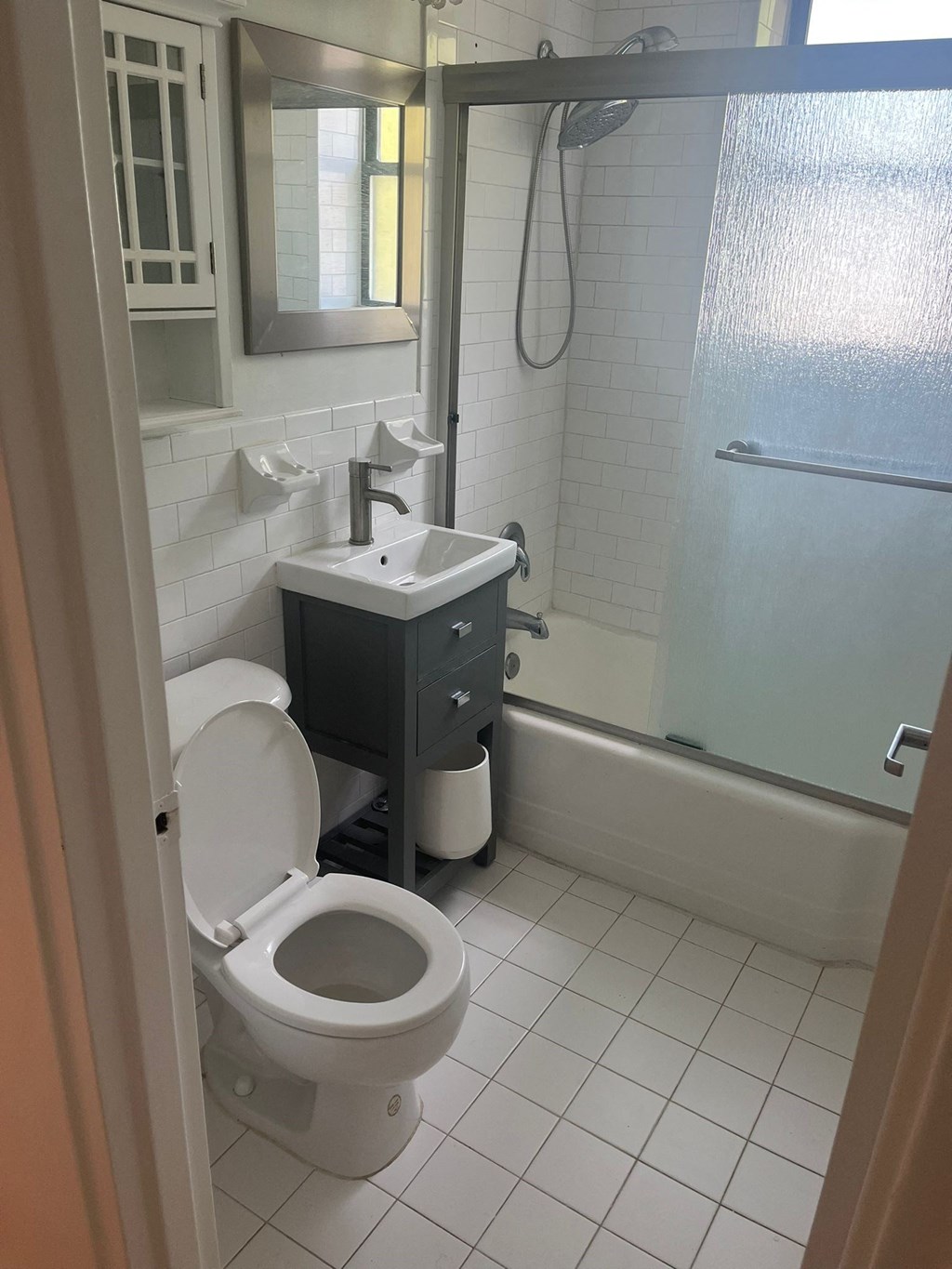 a bathroom with a toilet and a sink and a shower
