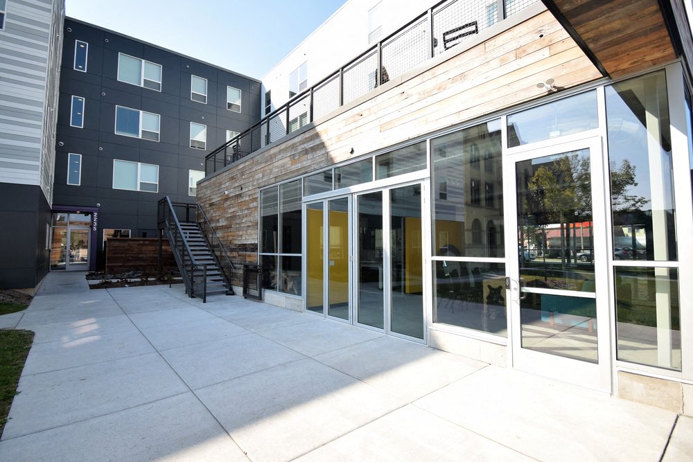 the entrance to a new building with glass doors