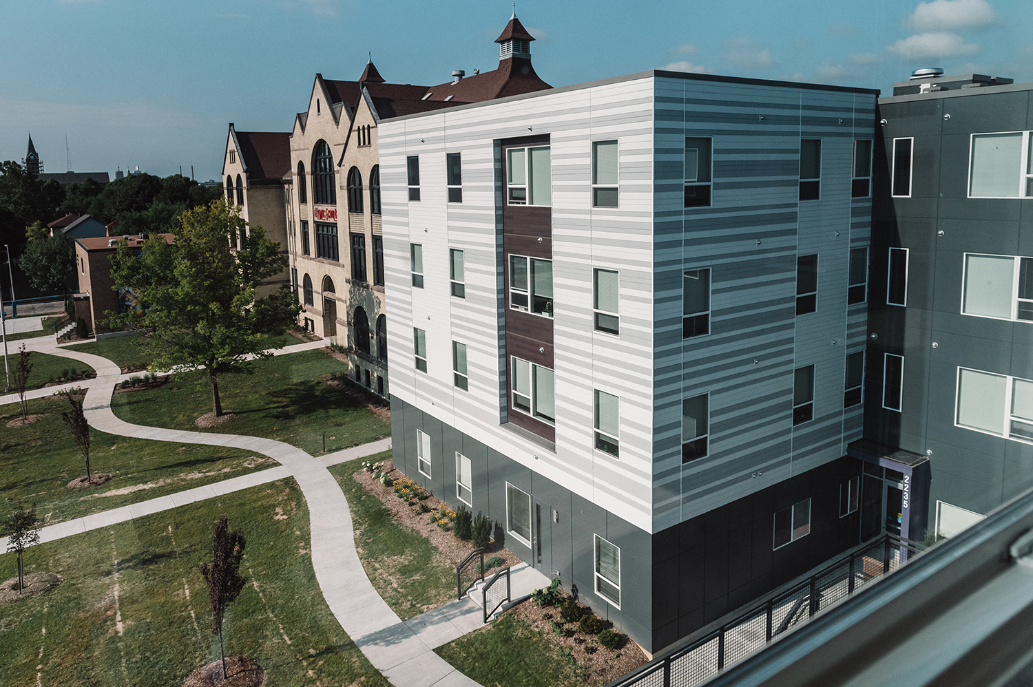 a modern building with a sidewalk in front of it