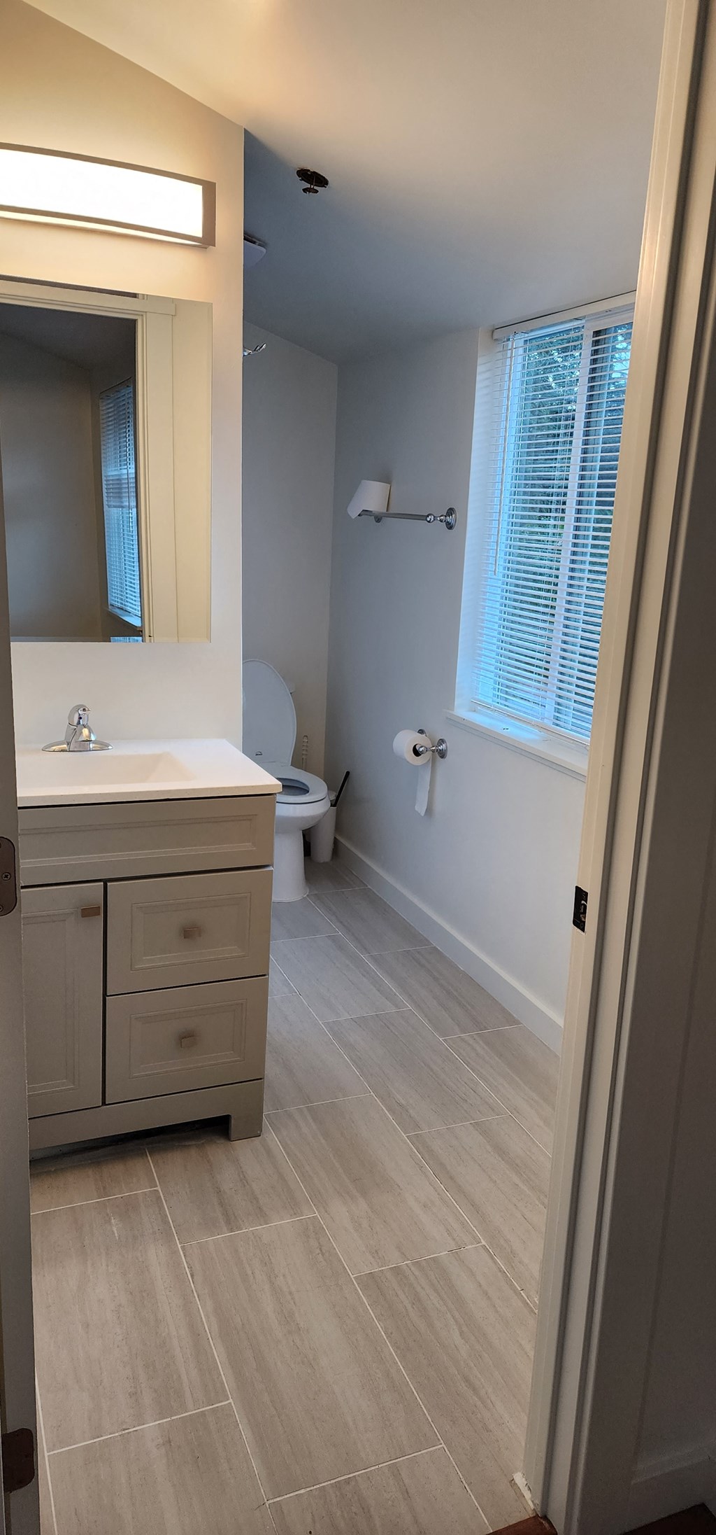 a bathroom with a sink toilet and a mirror