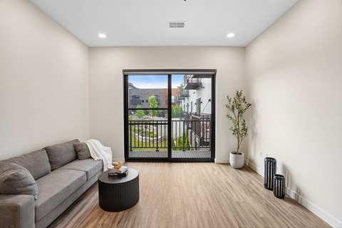 A living room with a grey couch and a coffee table.