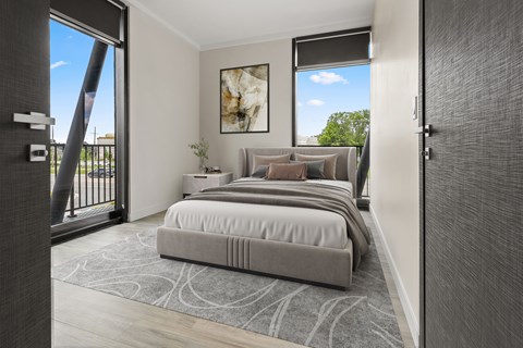 A bedroom with a large bed and a painting on the wall.