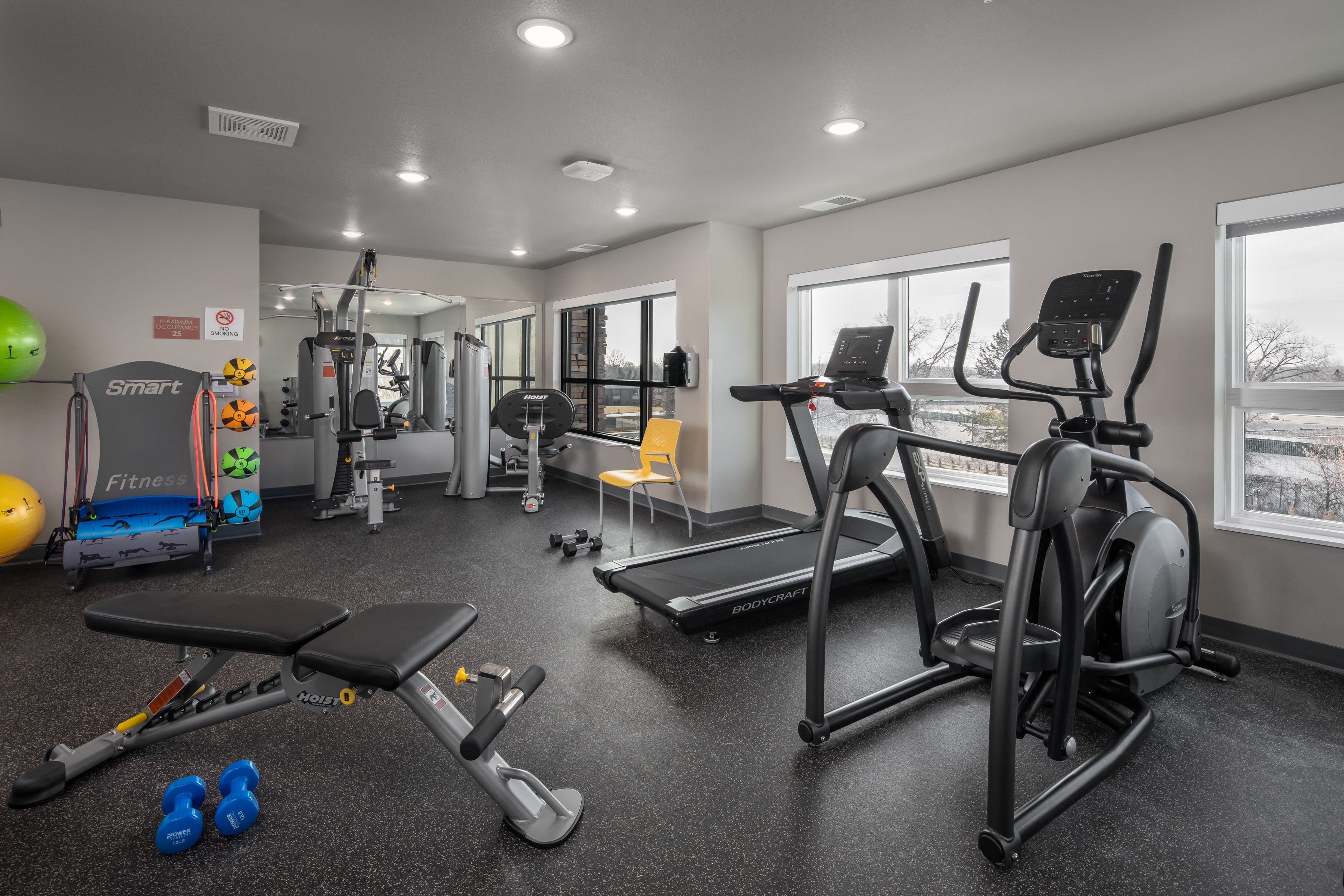 a gym with treadmills and other exercise equipment at the enclave at university heights