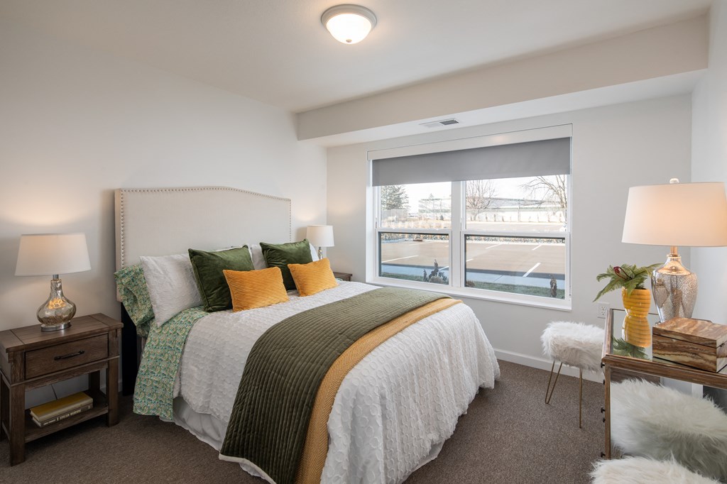 a bedroom with a large bed and a window