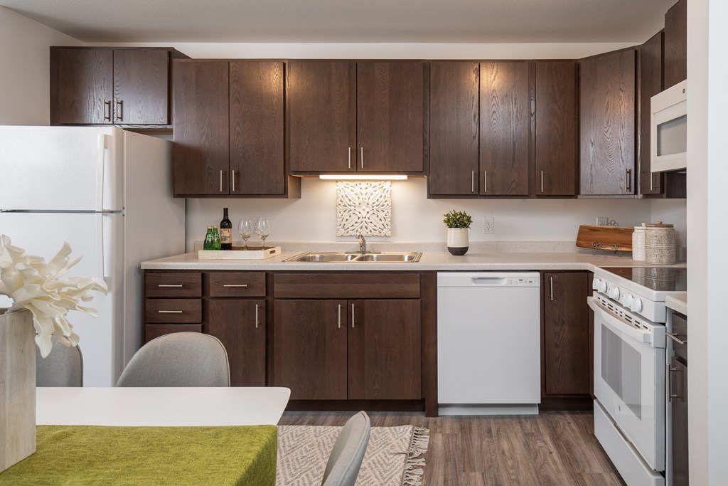 a kitchen with new appliances and dark wood cabinets