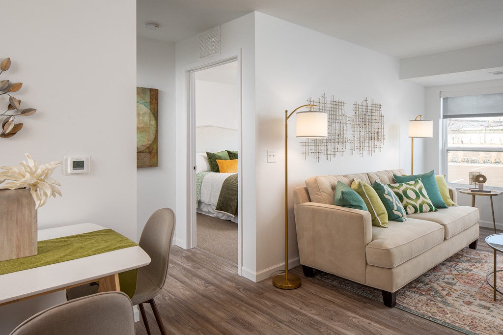 a living room with a couch and a dining room table