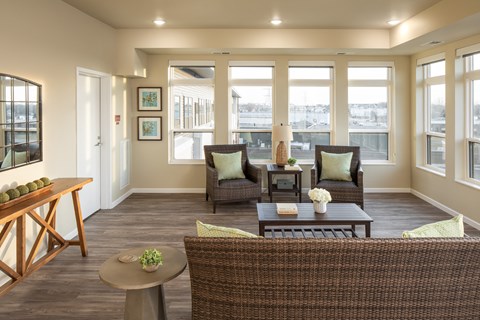 a living room with a couch and chairs and a table