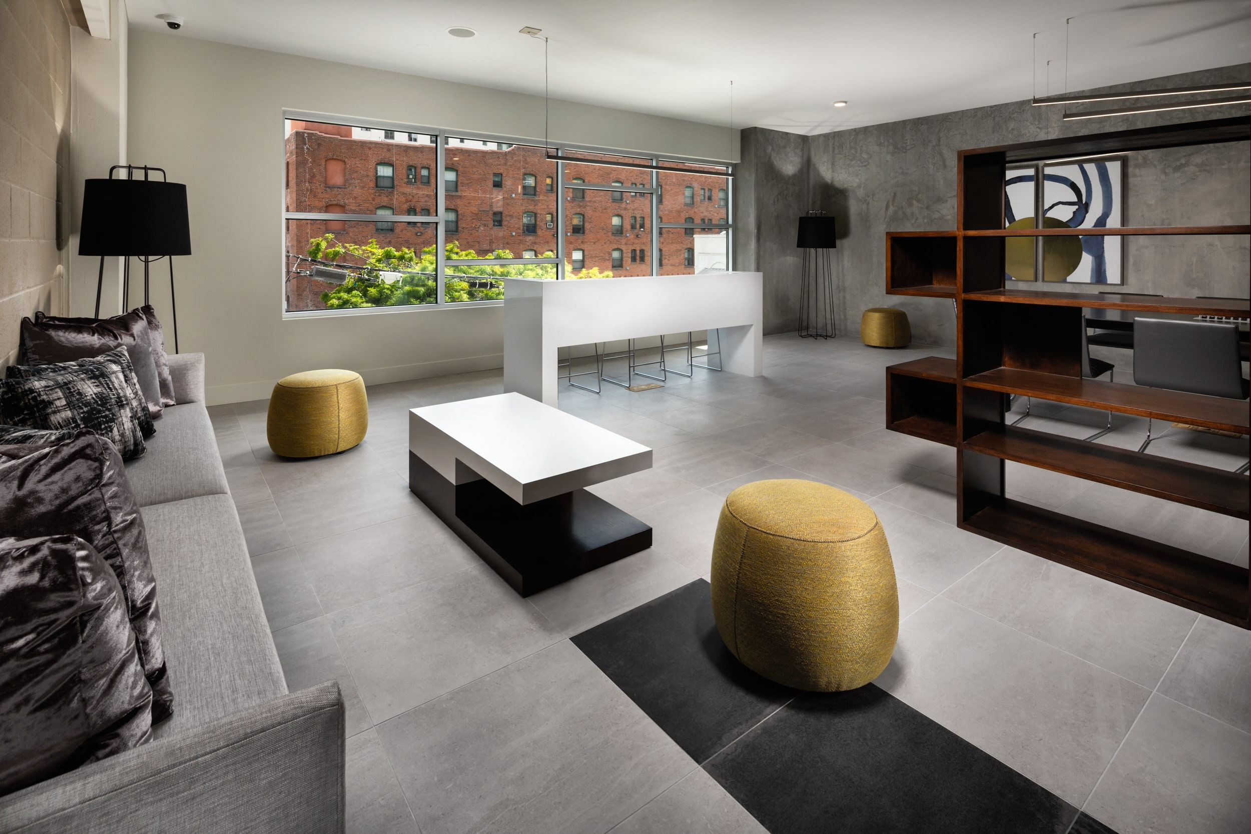 Seating area in clubhouse with couch, table, shelves