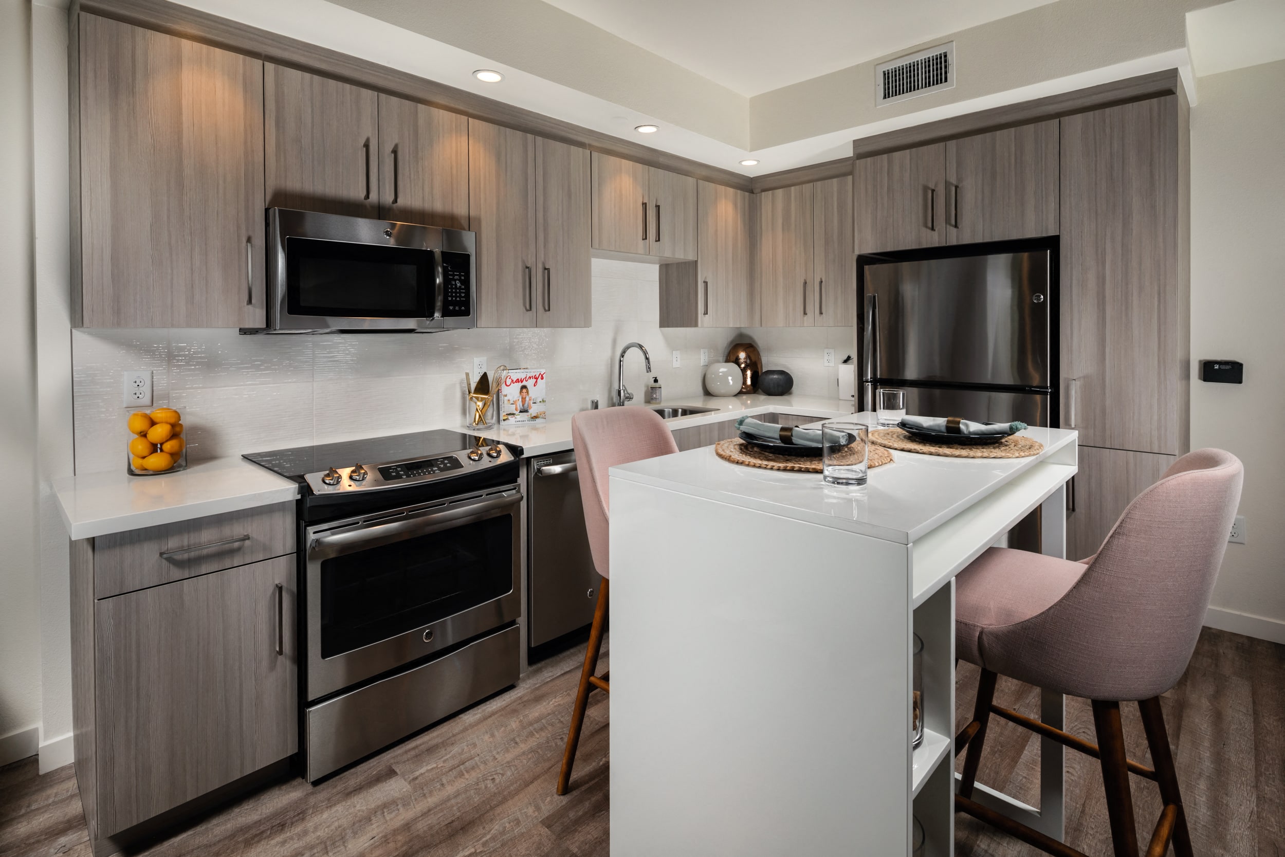 Kitchen with table and chair and steal appliances