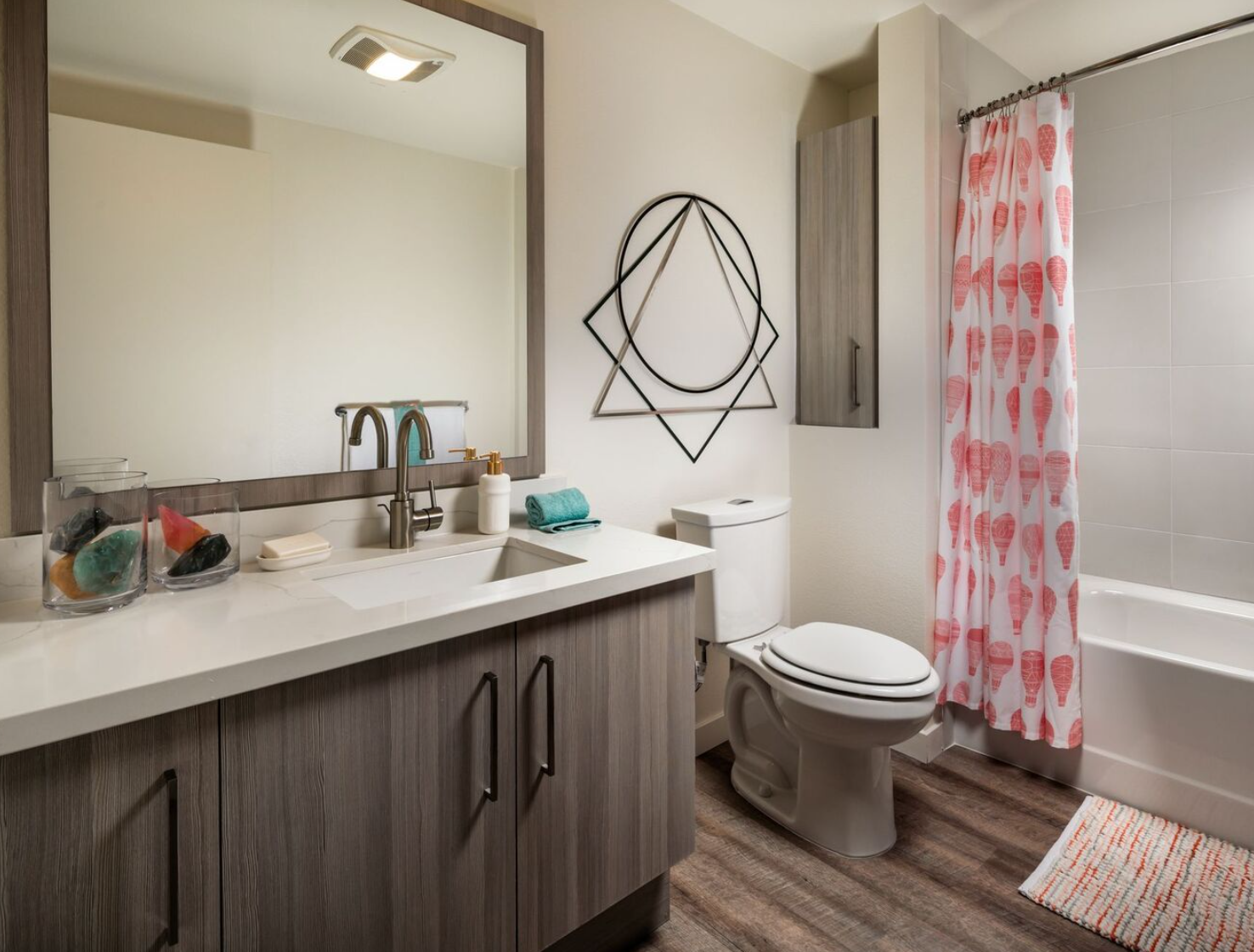 Bathroom with sink, large mirror, toilet, and bathtub