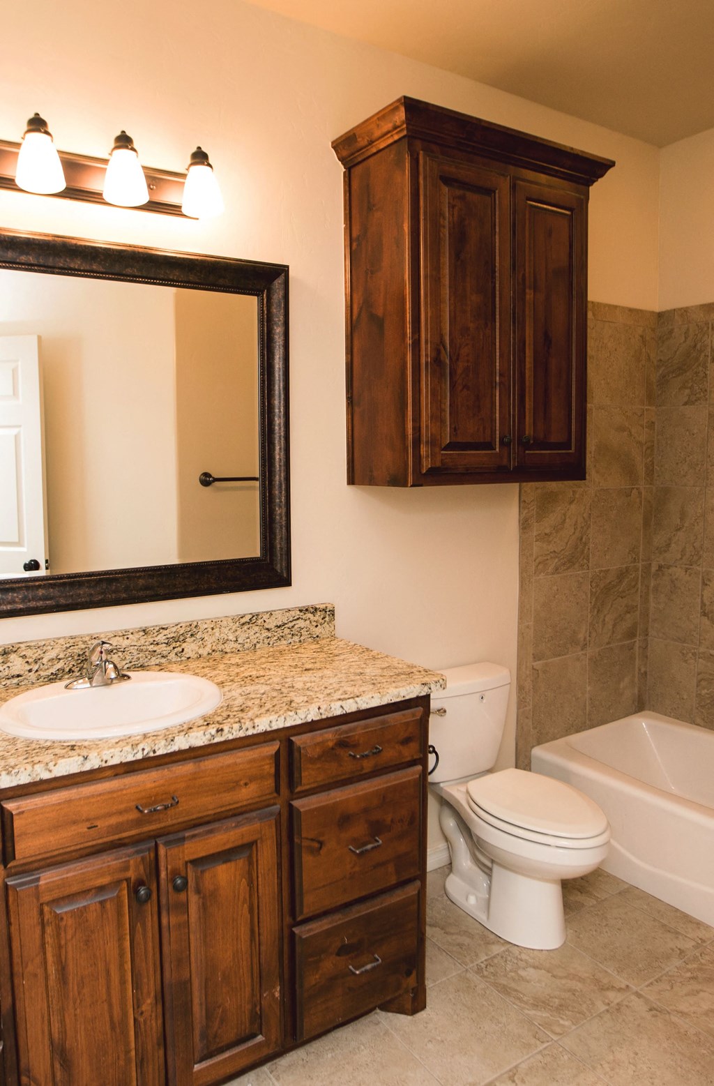 a bathroom with a toilet and a sink and a mirror