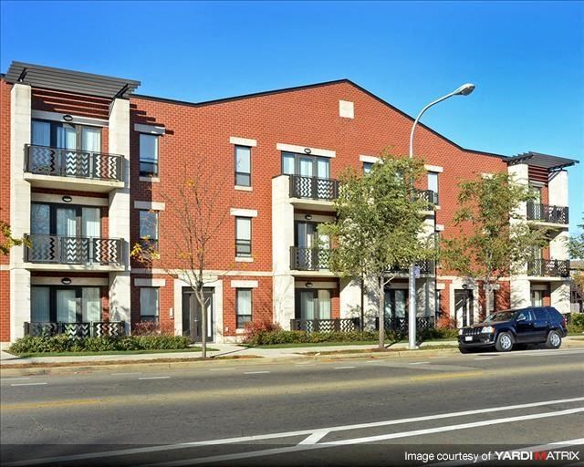 a car parked in front of a brick building