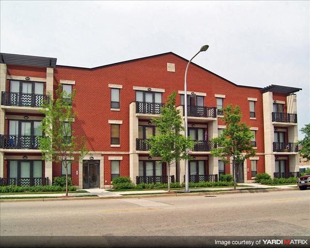 a red brick apartment building on the side of a street