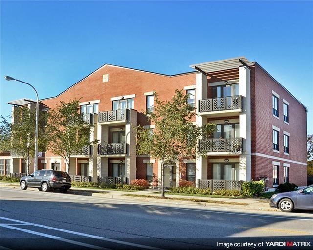 a brick apartment building on the side of a street