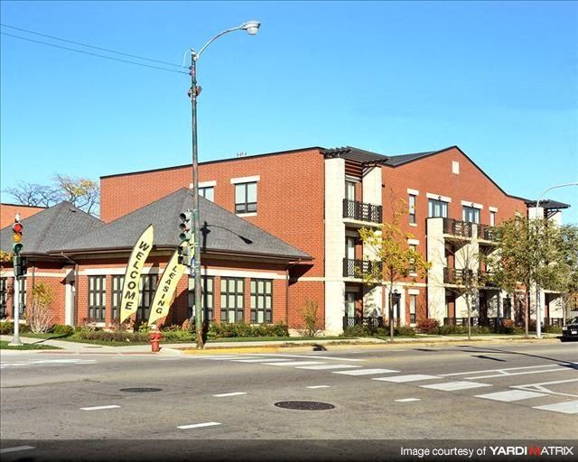 a large brick building on the corner of a street