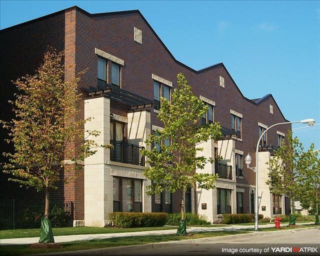 a large brick building with trees in front of it