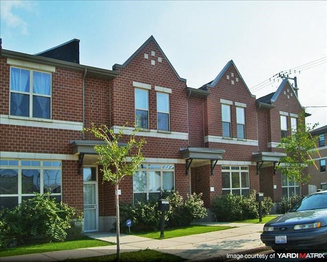 a brick house with a car parked in front of it