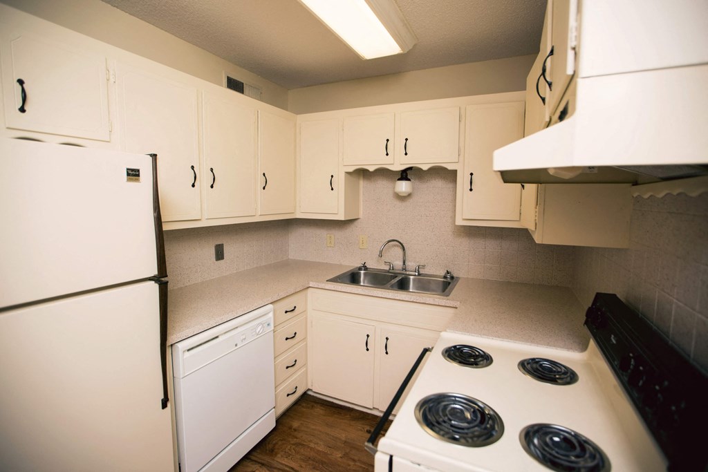 a kitchen with white appliances and white cabinets
