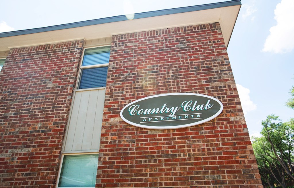 a sign on the side of a brick building