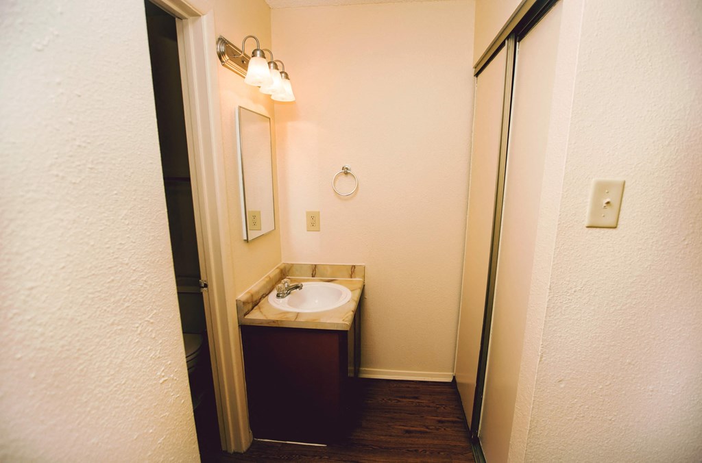 a small bathroom with a sink and a mirror