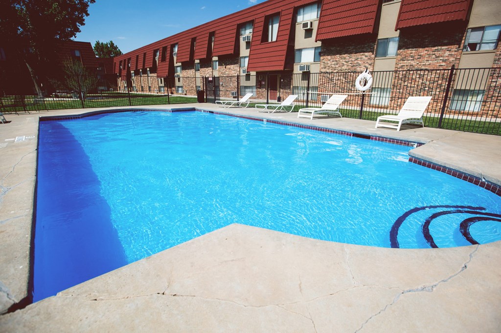 a large swimming pool in front of a resort style building