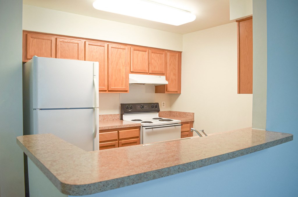 a kitchen with a counter top and a refrigerator