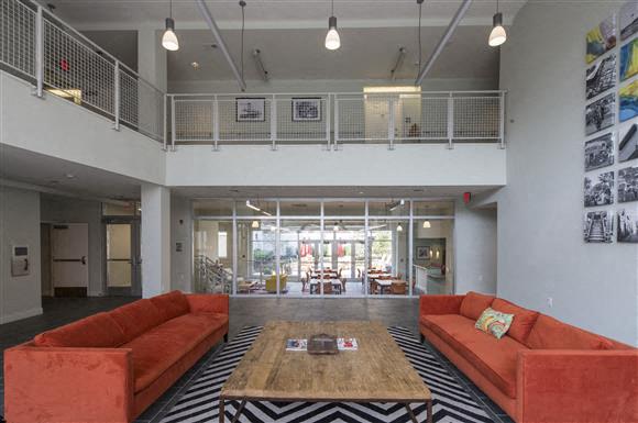 a living room with orange couches and a coffee table
