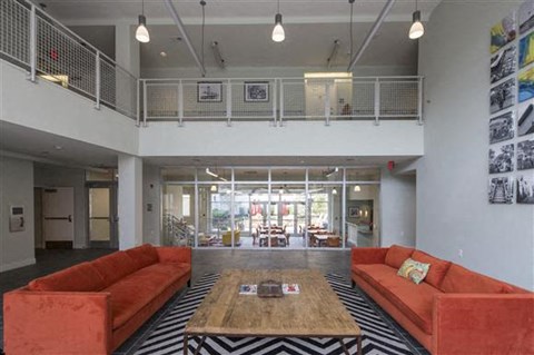 a living room with orange couches and a coffee table