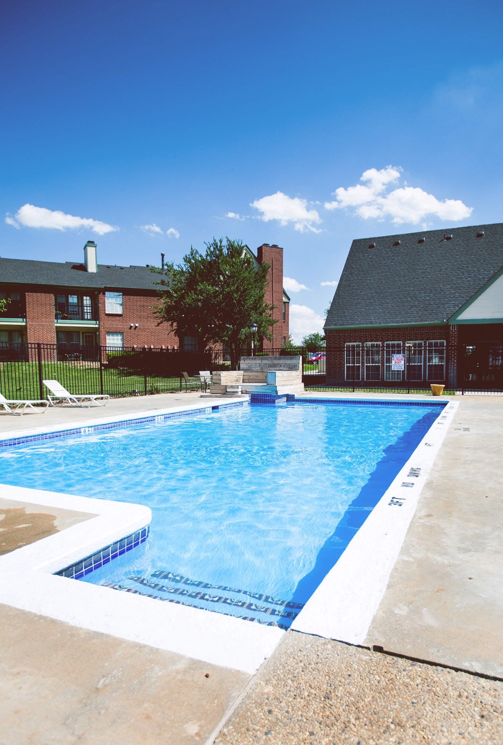 a swimming pool with a building in the background