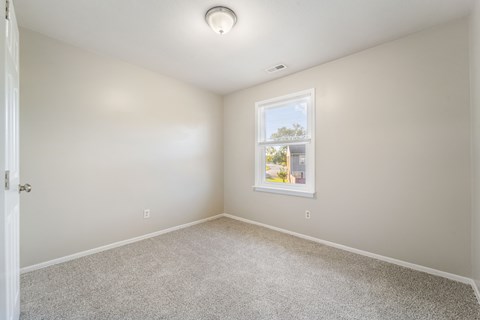 A room with a window and a door.