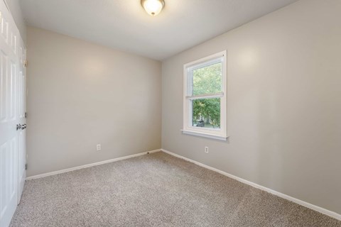 A room with a window and a door.