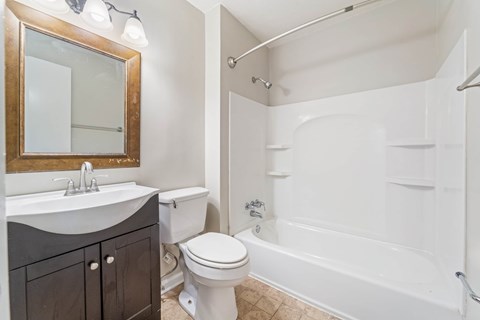 A white toilet sits next to a sink in a bathroom.