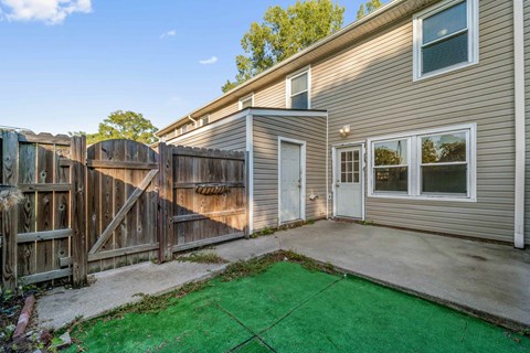 A house with a green lawn in front.