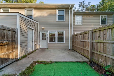 A house with a green lawn in front.