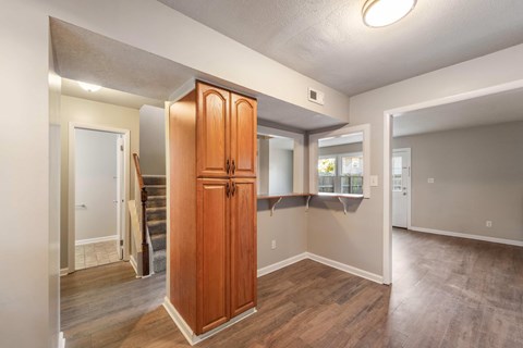 A room with a wooden floor and a wooden cabinet.