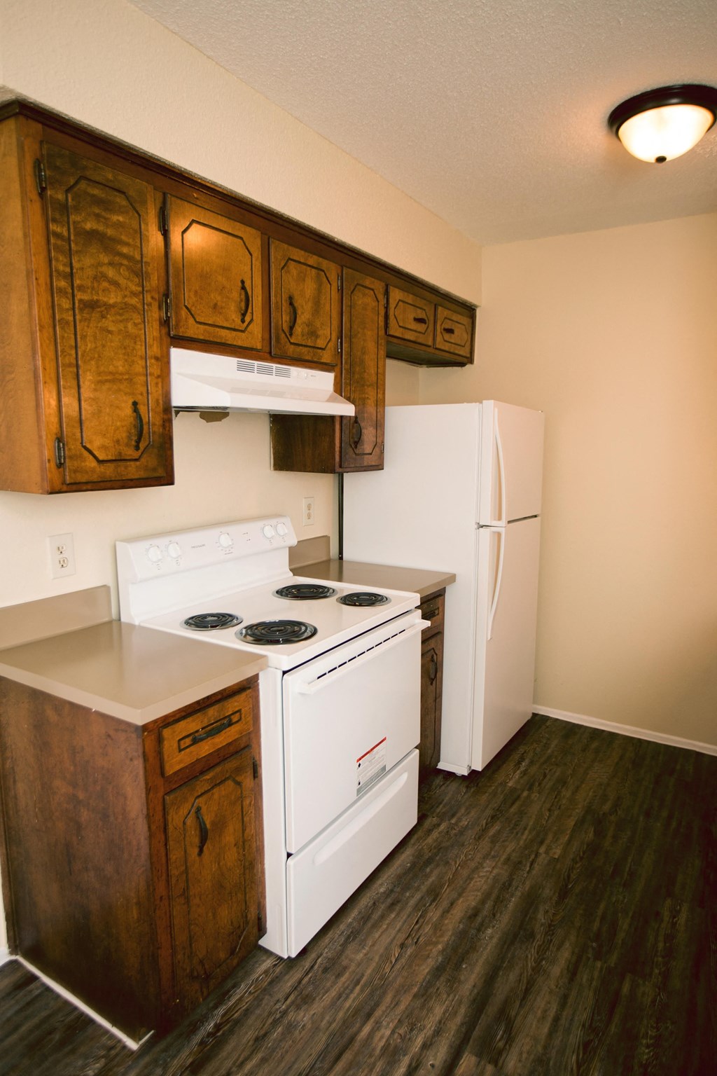 a kitchen with a stove and a refrigerator