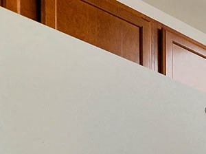 a kitchen with white appliances and wooden cabinets